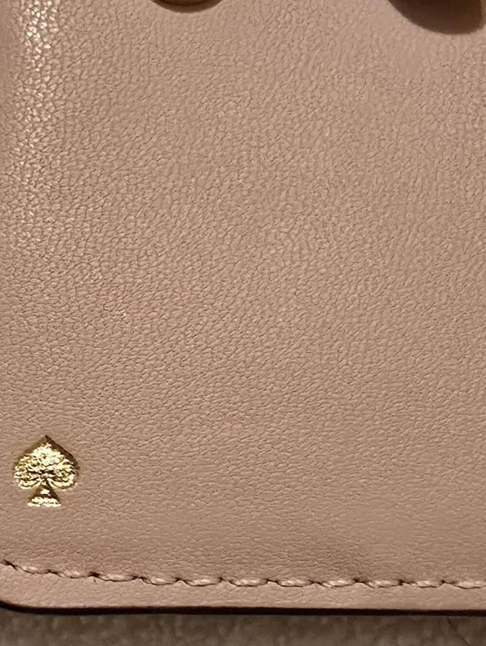 Kate Spade New York Staci small zip-around bifold wallet featuring a glittery ro
